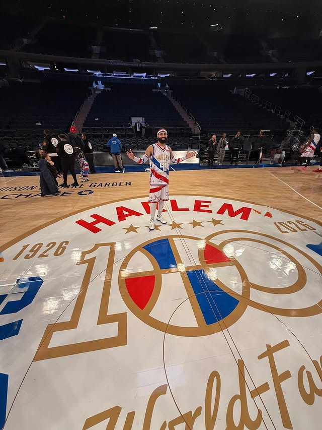 Lou Dunbar II at Madison Square Garden on the Harlem 100 center-court logo